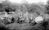 A melodeon player with three young men and a soldier on a donkey!